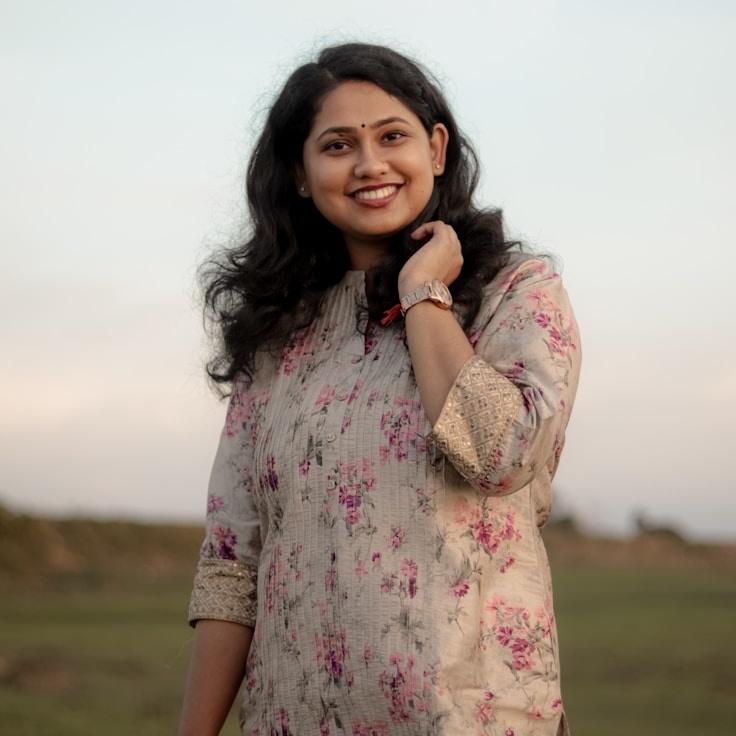 Kaveri Mehta, Lead Design Curator at HollowGroveField, reviewing corporate floral arrangements